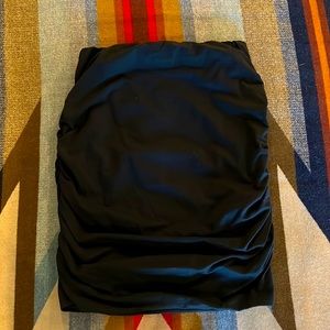 Stretchy tube skirt. Ruched on both sides.